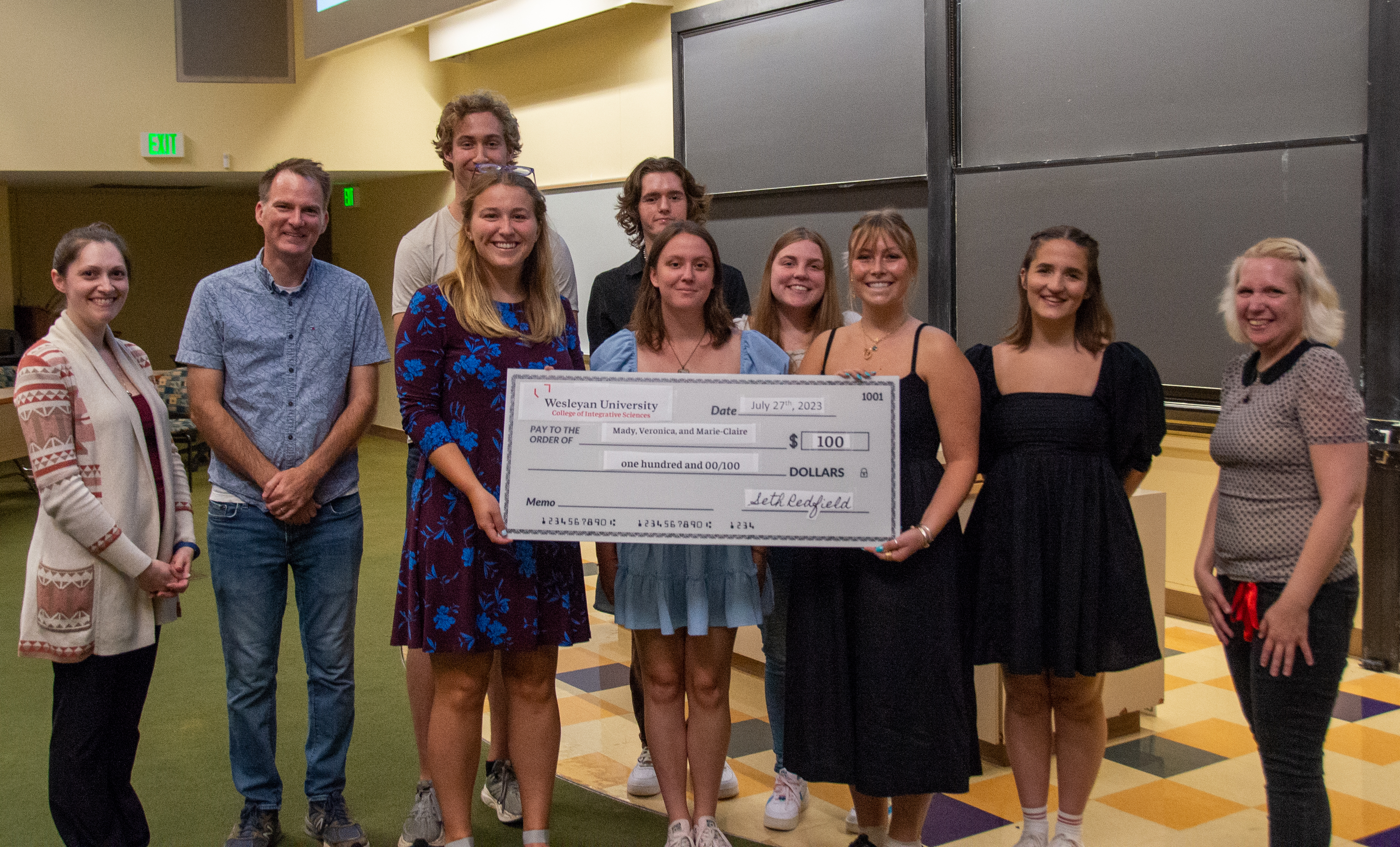 The prize winners receive a giant check